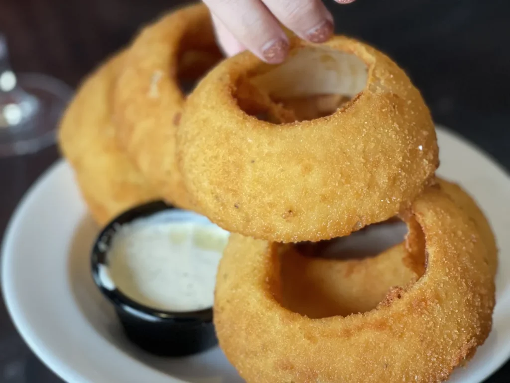 Thick, hand-battered onion rings come served with must-try fire-roasted jalapeno ranch. Melissa Corbin/Eater Nashville